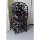 A modern freestanding black wrought iron wine rack, enclosed by a round arched door  40"h  18"w; and