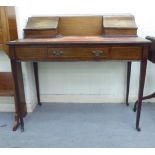 An Edwardian mahogany writing table, the top with a pair of lidded compartments, decorated in