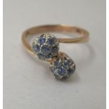 An 18ct gold double cluster ring, set with fourteen blue stones