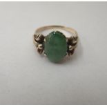 A 14ct gold ring, set with a cabouchon cut jade stone