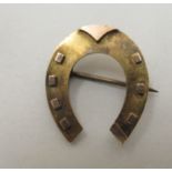 A 15ct gold brooch, fashioned as a horseshoe