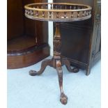 A late 19thC style mahogany pedestal table with a galleried top, over a wrythen carved column,