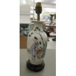 A 20thC Chinese porcelain vase lamp, decorated with figures, in a garden setting  10"h