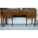 An Edwardian mahogany serpentine front sideboard, comprising a central drawer, flanked by a pair