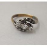 An 18ct gold crossover ring, set with nine diamonds