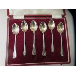 A set of six silver teaspoons, the reverse of each bowl decorated with embossed ornament