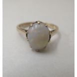 A 9ct gold ring, set with a cabochon cut opal