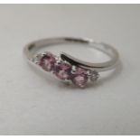 A 9ct white gold ring, set with pink stones and diamonds