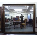 A modern mirror, in a swept gilt frame  79" x 84"