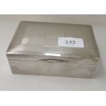 A silver cigarette box with an engine turned hinged lid  indistinct Birmingham mark  2"h  5"w