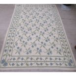 A modern rug with geometric motifs, on a beige ground  70" x 120"