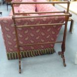 An early 20thC mahogany towel rail, on decoratively pierced plank ends and scrolled feet  36"h  26"w