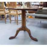 A George III and later mahogany tip-top breakfast table, over a turned, tapered column, raised on