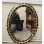 A modern mirror, in a black and gilt frame with glass bead ornament  28" x 37"