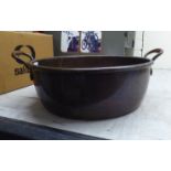 A late 19thC copper preserve pan with a rolled lip and riveted handles  16"dia