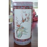 A modern Chinese porcelain cylindrical stickstand, traditionally decorated in colours and panels