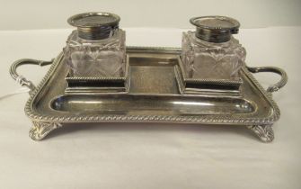 A Georgian style silver standish, the tray with gadrooned borders, opposing loop handles, twin pen
