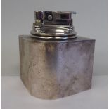 A Cartier two part, gas filled table lighter of lozenge form, in a loaded Sterling silver holder