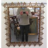 A late 19thC inspired wall mirror, set in a wide, decoratively cast gilded metal frame  30" x 26"