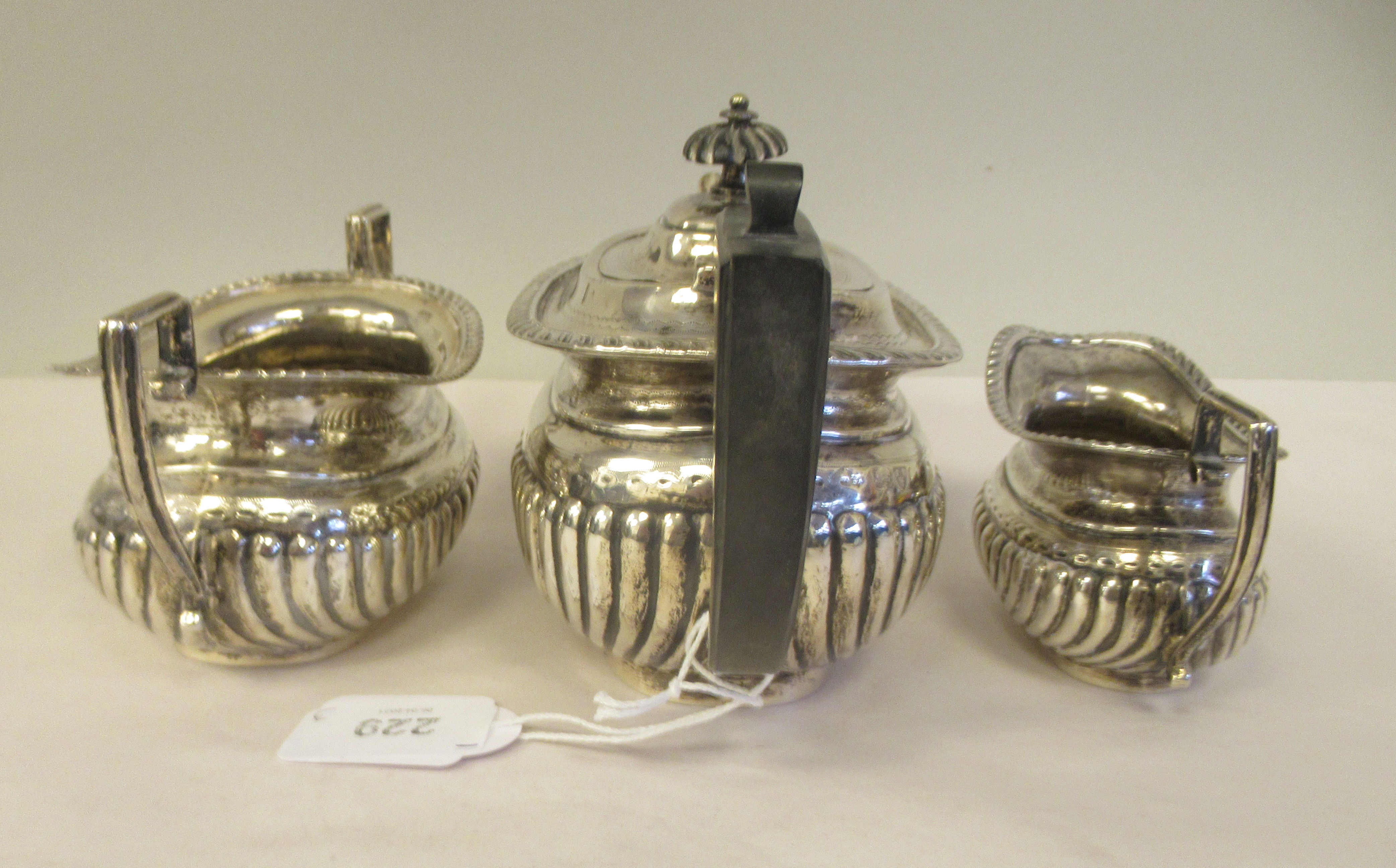 An Edwardian batchelor's three piece silver tea set of oval, ogee shape, demi-reeded form, - Image 3 of 9