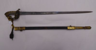 An early 20thC British naval officer's dress sword with a lion's head pommel and wire bound fishskin