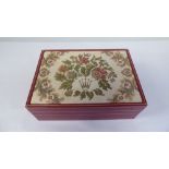 A Rolex presentation casket, finished in tooled and gilded red hide with a floral tapestry lid,