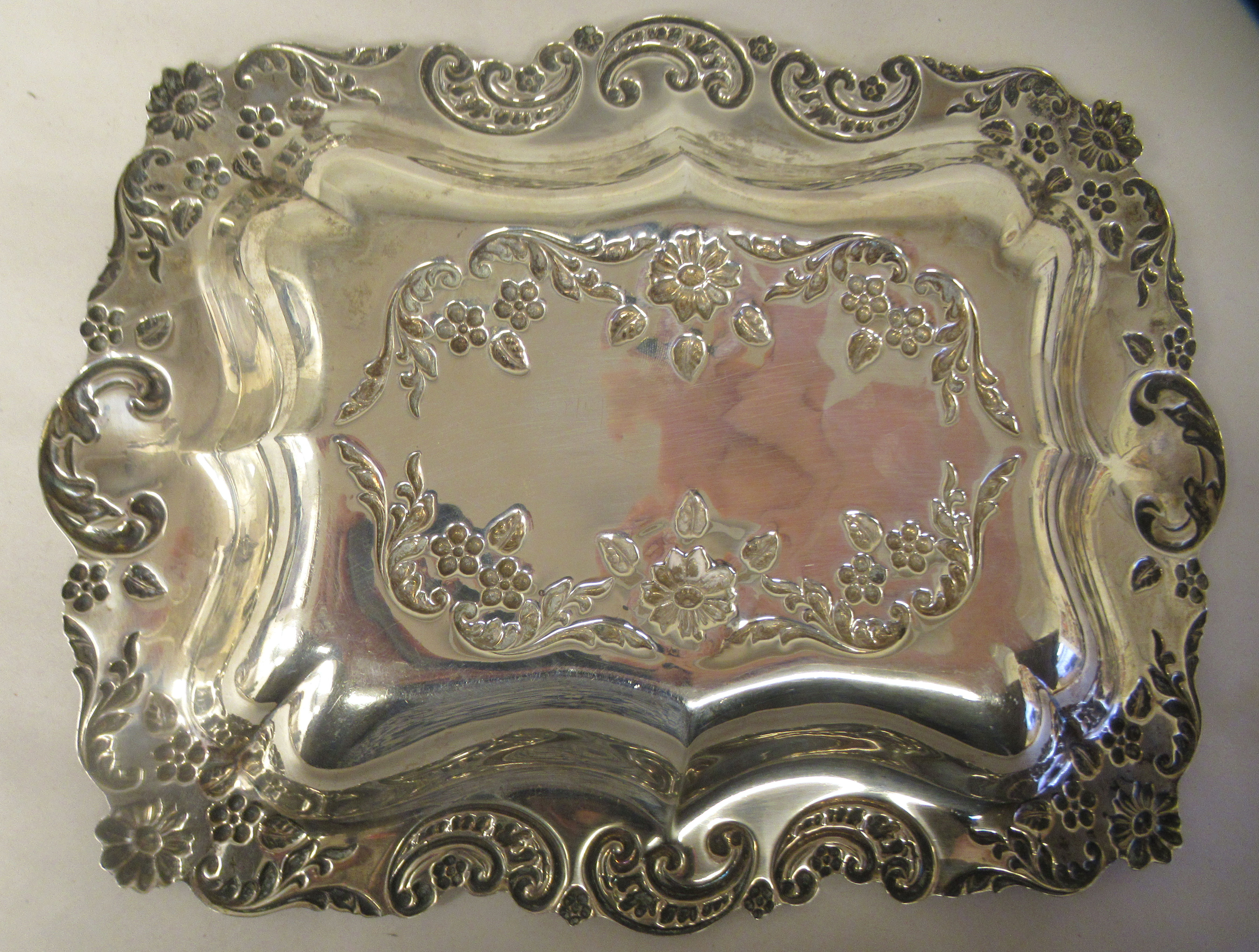 An Edwardian silver dressing table tray with a dished centre, embossed and chased foliate scrolled - Image 2 of 4