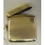 A 9ct gold vesta case with engine turned decoration, a hinged cap, strikeplate and suspension ring