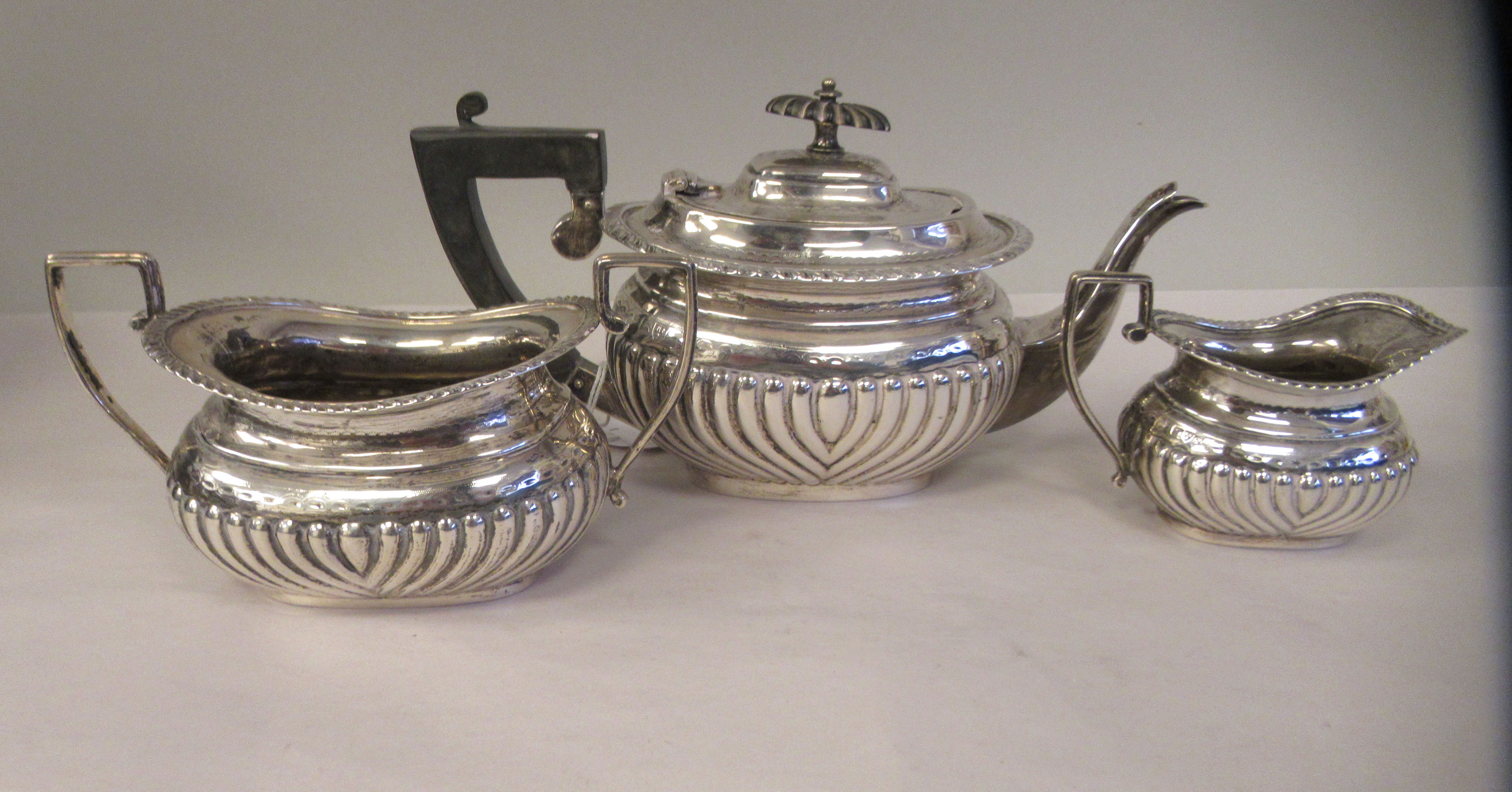 An Edwardian batchelor's three piece silver tea set of oval, ogee shape, demi-reeded form, - Image 6 of 9