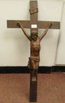 A late 19thC carved oak crucifix, a banner on the cross, inscribed 'RNRI' and inscribed L Verbeke
