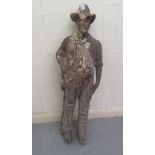 A late 19th/early 20thC carved limewood papier mache mould, featuring a standing cowboy  39"h