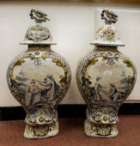 A pair of 19thC Continental Delft vases of waisted, flattened baluster form with covers and bird