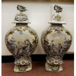 A pair of 19thC Continental Delft vases of waisted, flattened baluster form with covers and bird