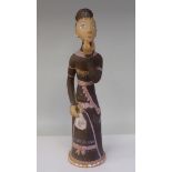 A Margit Kovacs art pottery figure, a woman in a brown dress, holding a handkerchief  16"h