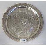 A Middle Eastern silver coloured metal plate, allover decorated with engraved arabesque designs
