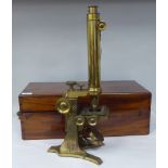 A late Victorian lacquered brass binocular microscope with numerous attachments and accessories,