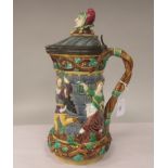 A late 19thC Minton's majolica tower jug, no.1231, decorated in colours with moulded dancing