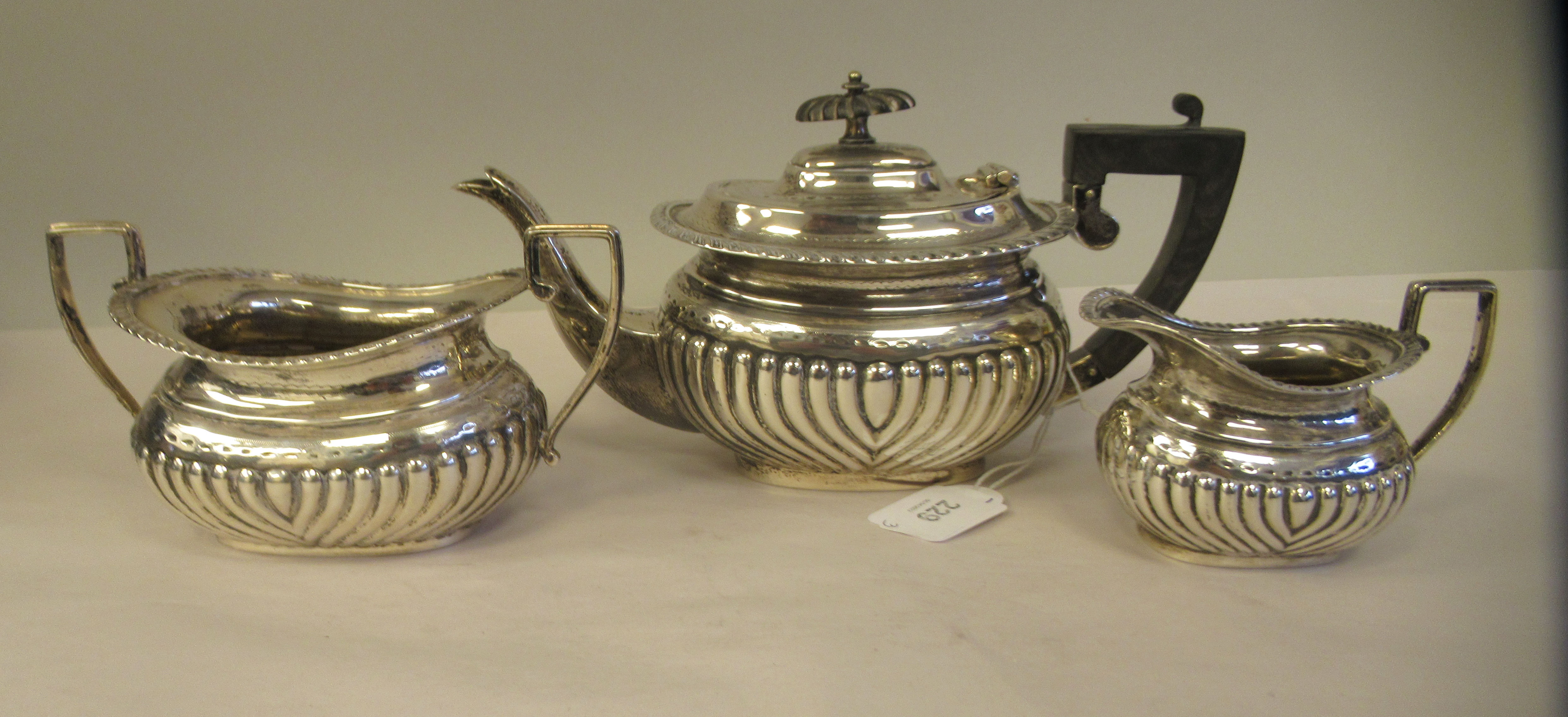 An Edwardian batchelor's three piece silver tea set of oval, ogee shape, demi-reeded form, - Image 4 of 9