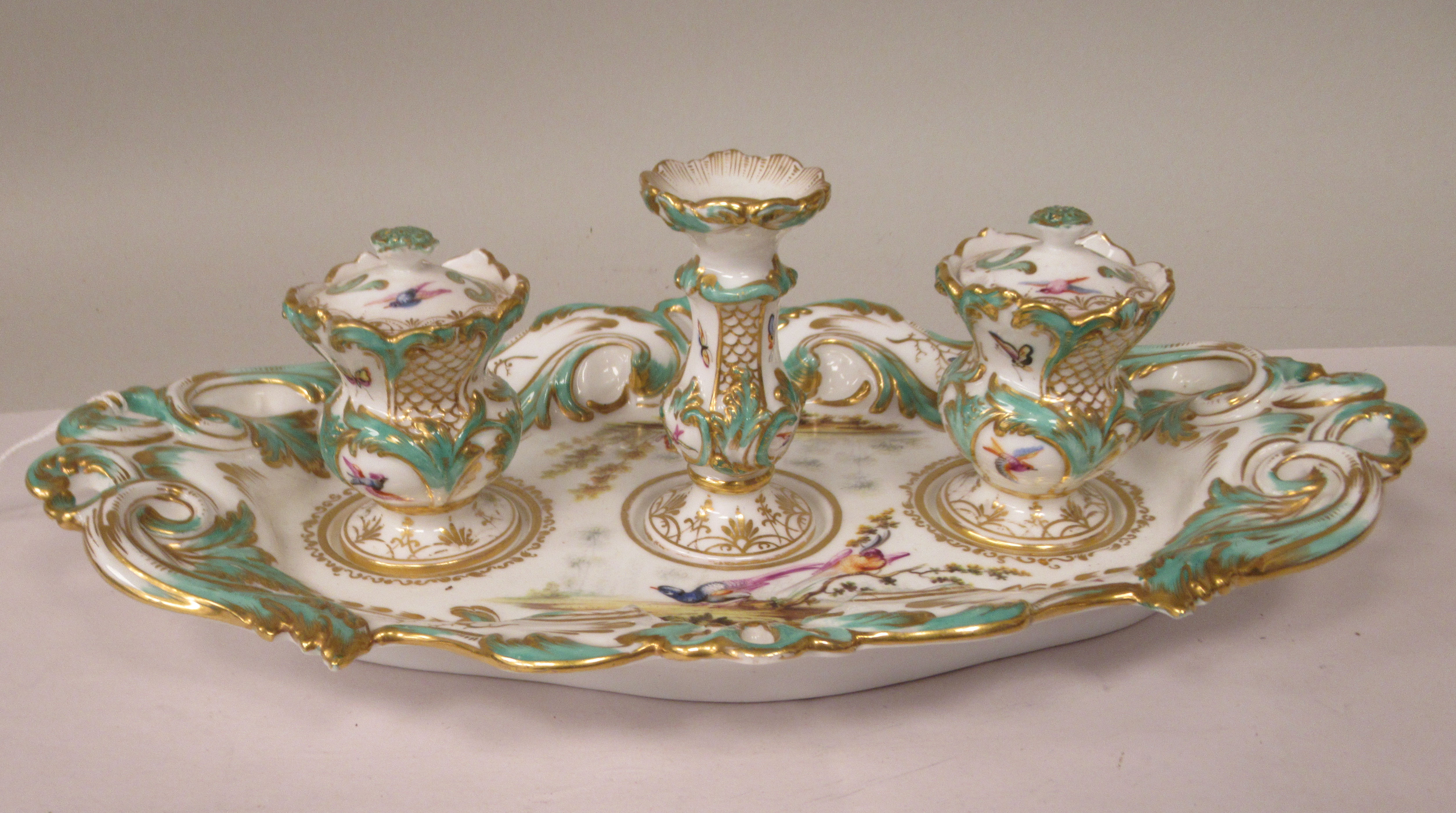 A late 19thC porcelain inkstand, the oval tray having a moulded, pierced and scrolled border and