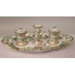 A late 19thC porcelain inkstand, the oval tray having a moulded, pierced and scrolled border and