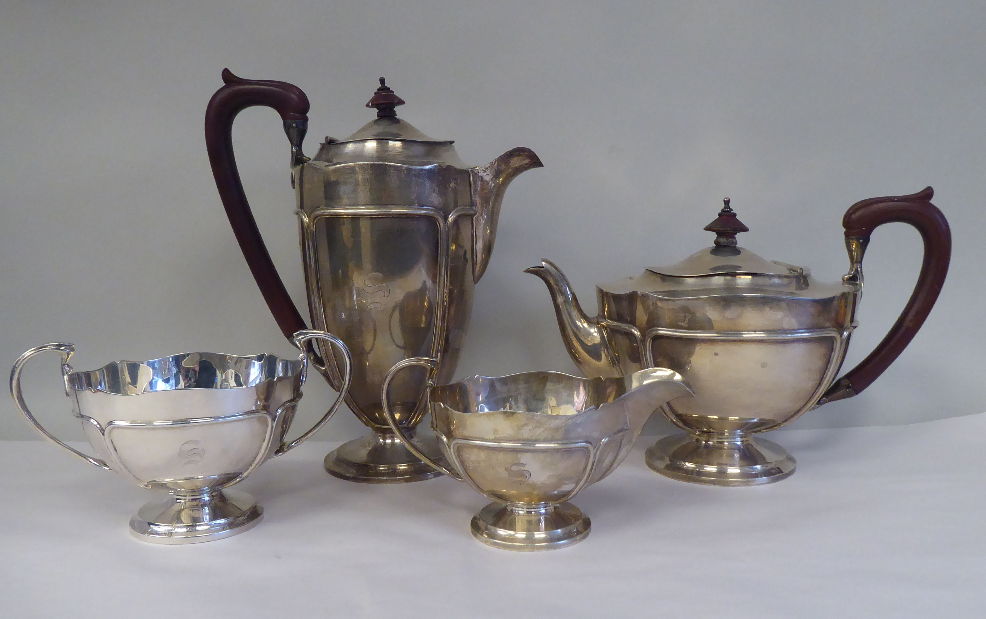 A four piece silver tea set, comprising a teapot of pedestal bowl display with an S-swept swept,