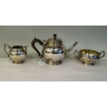 A three piece silver tea set of bulbous form, on a stepped footrim, comprising a teapot with an