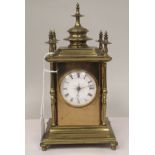 An early 20thC lacquered brass cased mantel clock, the straight sides with canted corners and outset