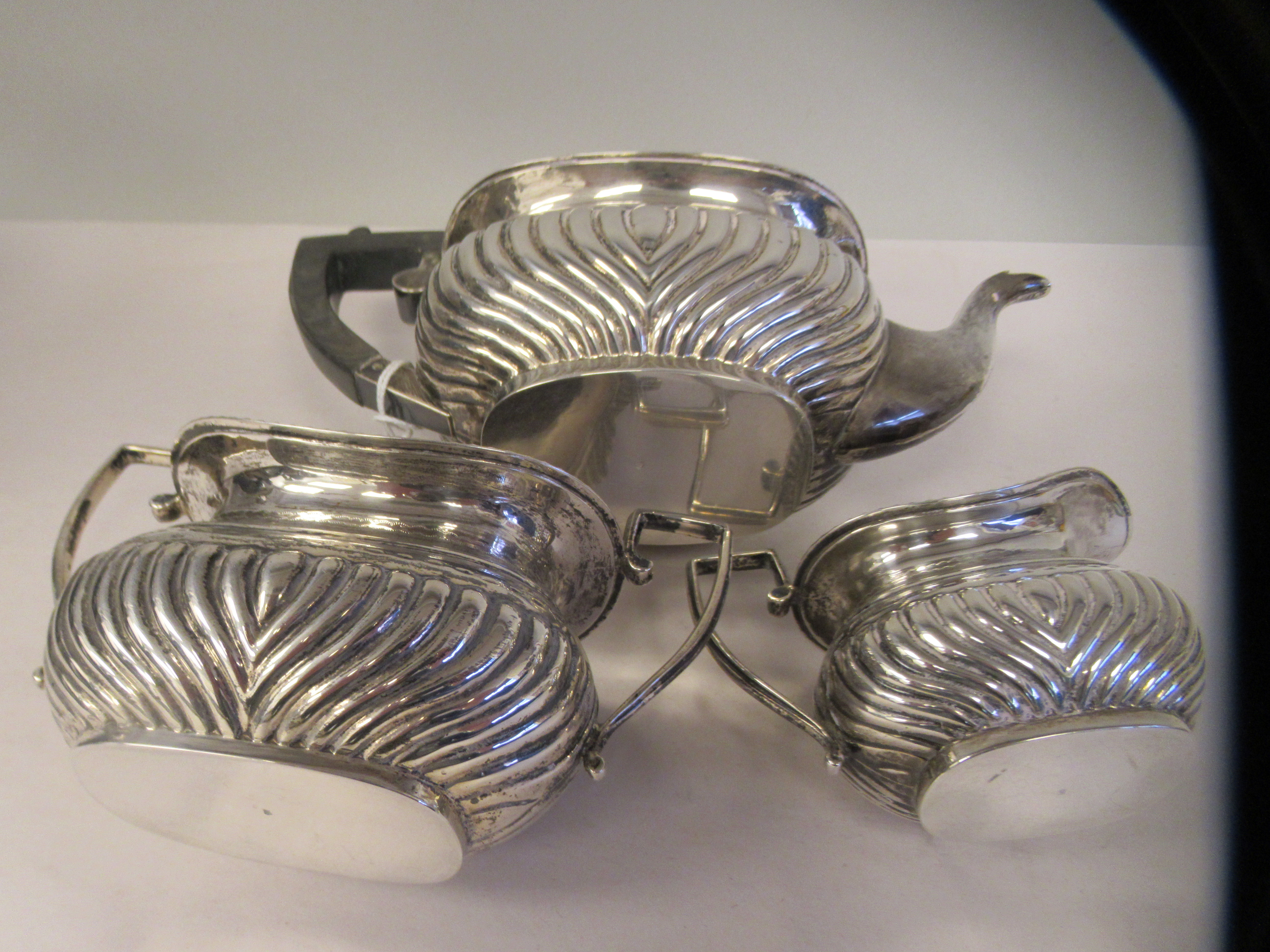 An Edwardian batchelor's three piece silver tea set of oval, ogee shape, demi-reeded form, - Image 8 of 9