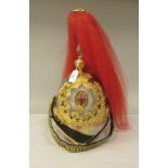 A British Cavalry officer's helmet with a chinstrap, red plume and adjustable liner (Please Note: