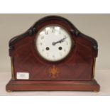 An Edwardian carved, string inlaid mahogany and marquetry cased mantel clock with a round arch top