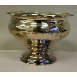 A silver rose bowl of tapered ogee form with an applied wire rim, elevated on a domed pedestal foot
