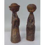 Two Margit Kovacs brown glazed art pottery standing figures, a man playing a pipe and a woman with