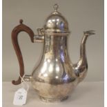 A Georgian style silver pear design hot water pot with an S-shape spout, insulated handle and an