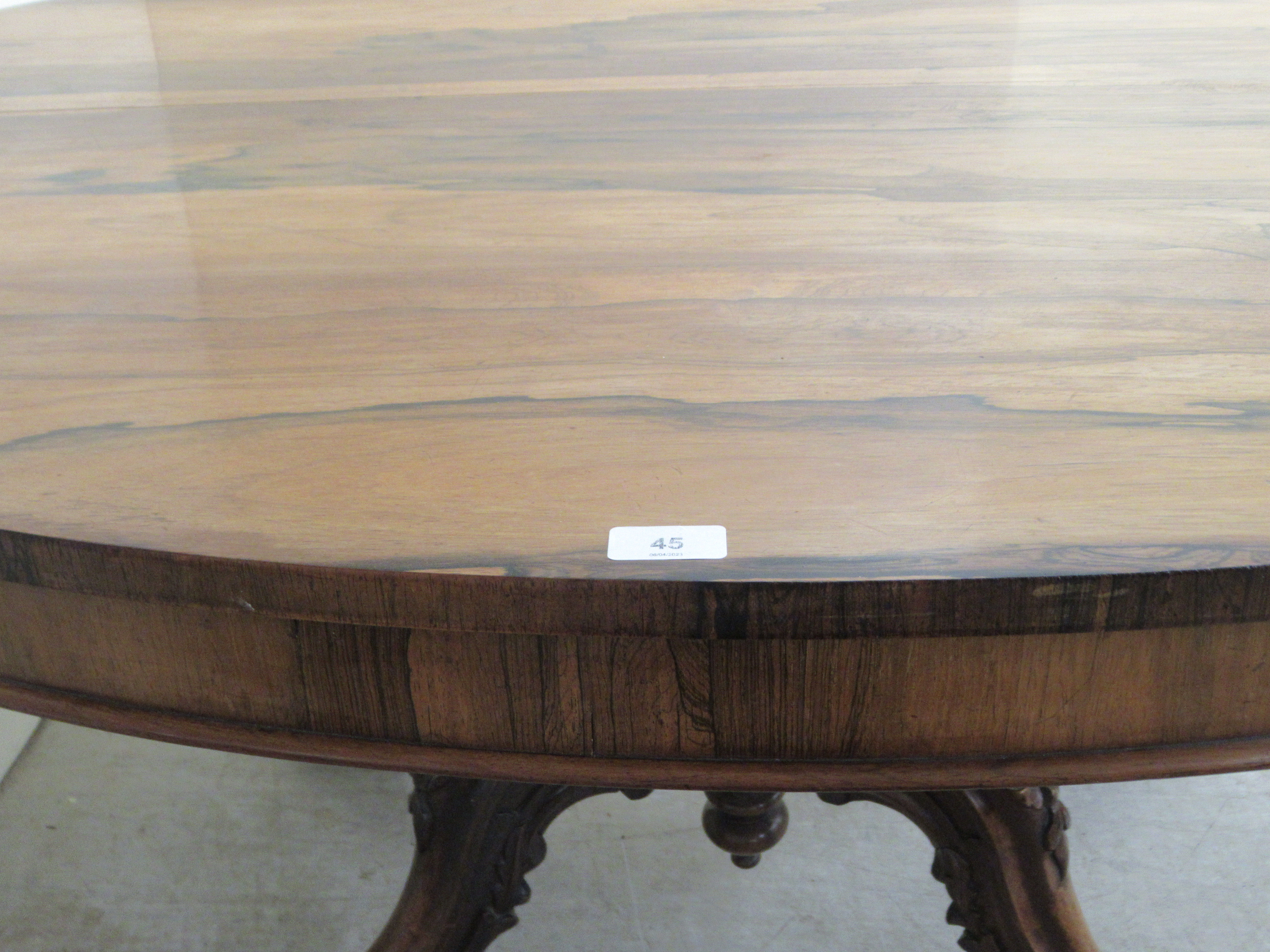 A mid Victorian rosewood breakfast table, the oval, figured veneered tip-top over a turned column - Image 7 of 10